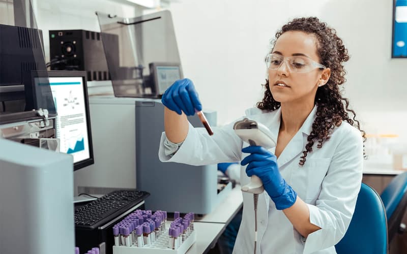 Lab technician scanning a blood vial